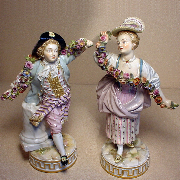 Meissen figures of a boy and a girl with garlands of applied flowers. Model number F67