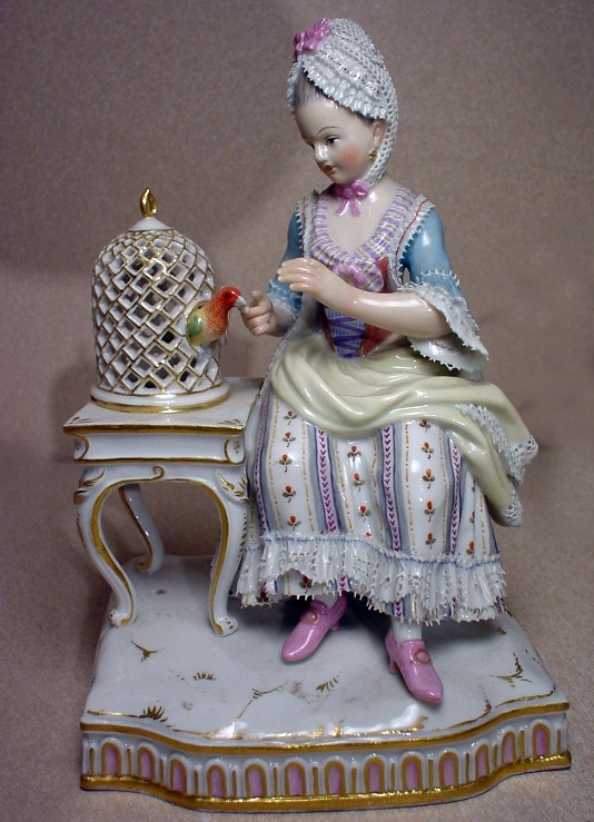 Meissen E4 figurine "Touch" from Five Senses series. Girl feeding a bird trapped in the bird cage