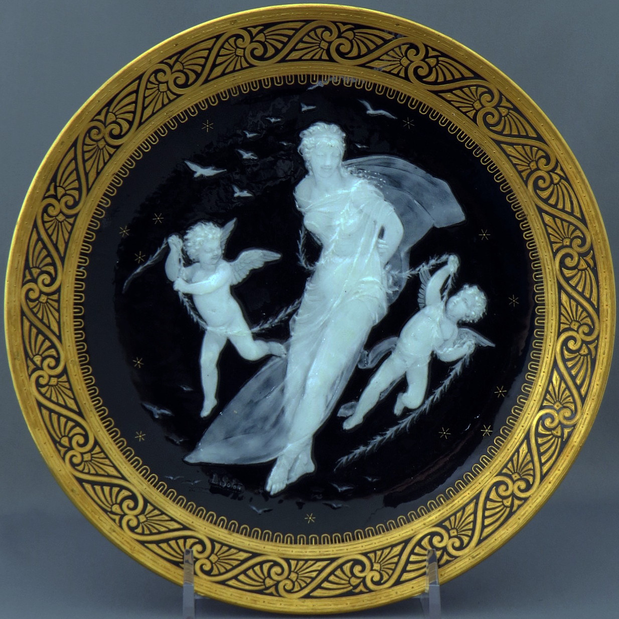 Minton pate-sur-pate plate signed Solon depicting a girl and two cupids
