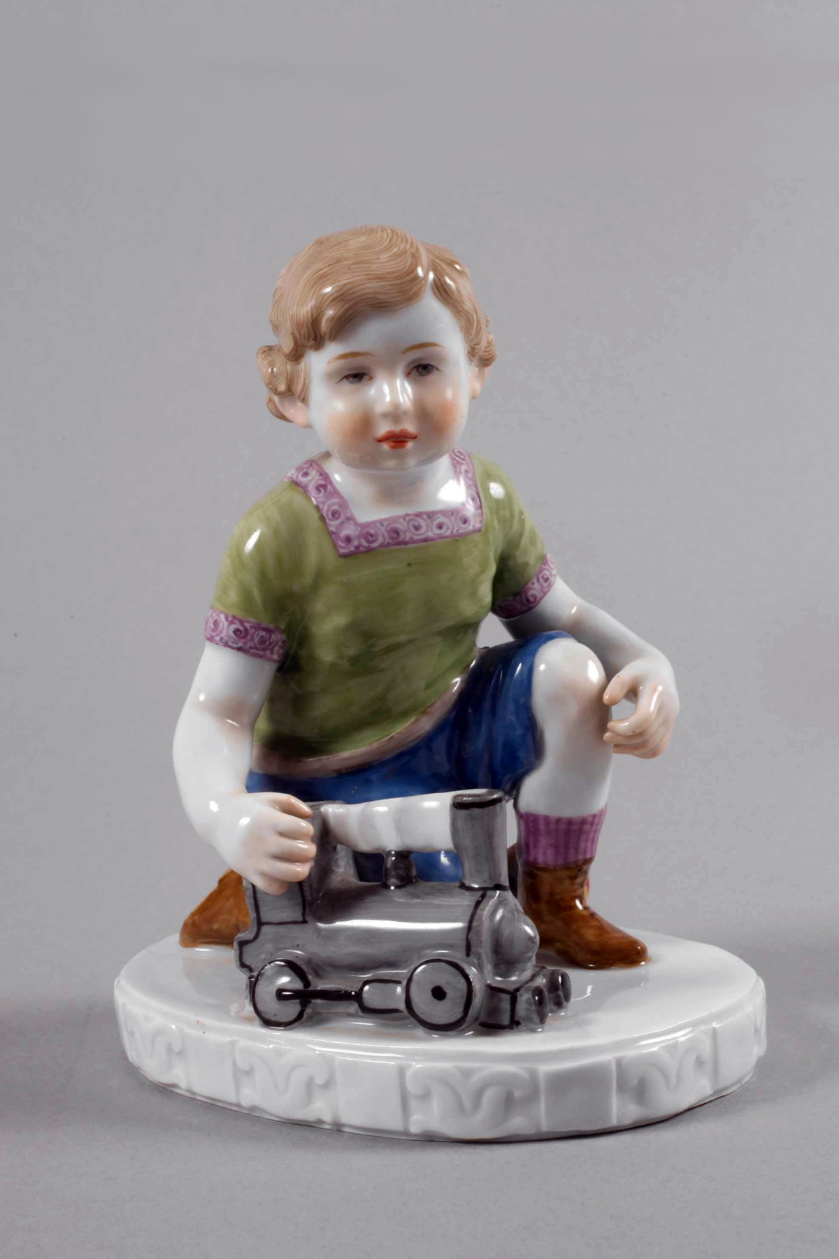 Meissen boy with toy train by Oehler. Model A232
