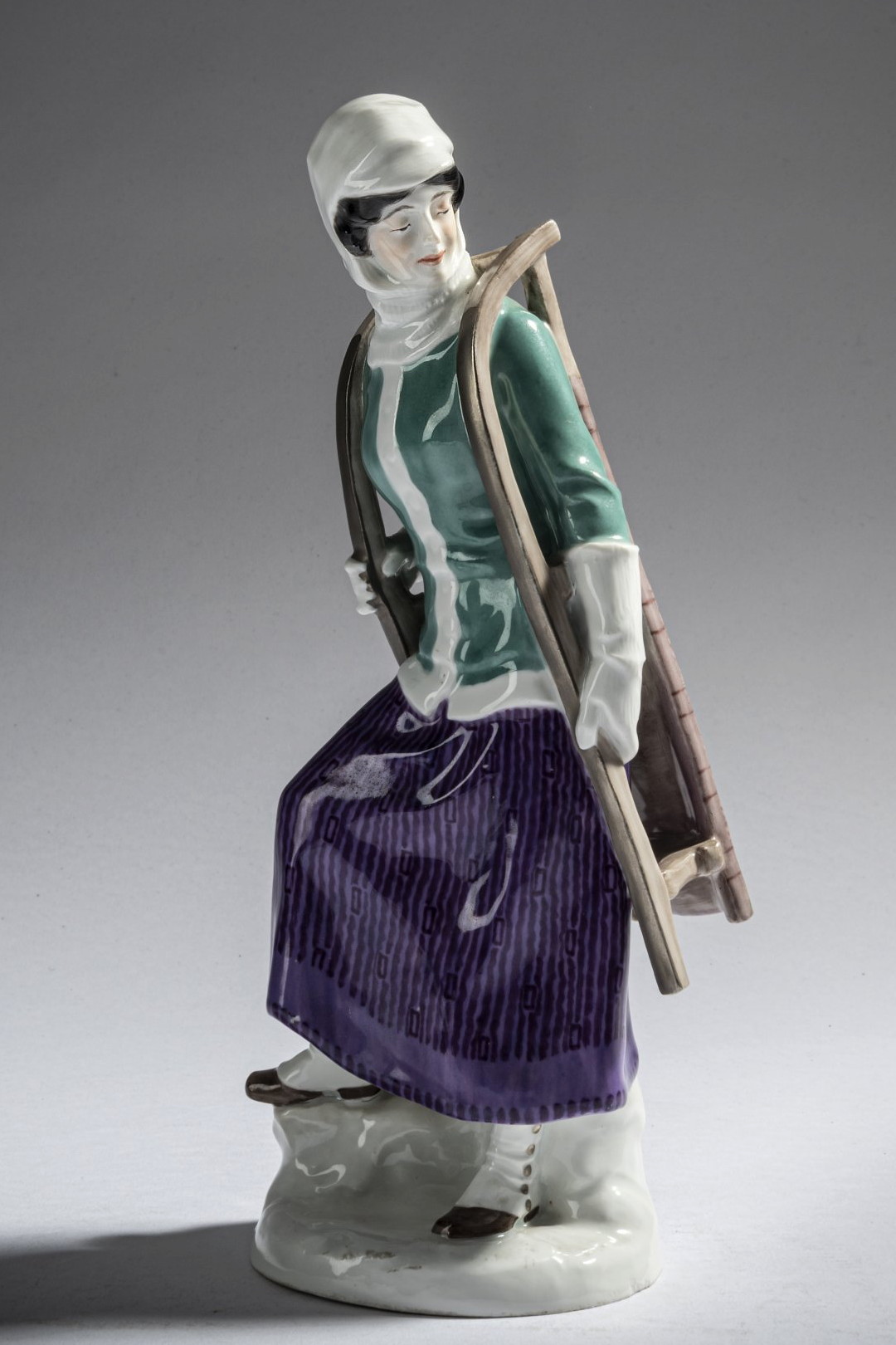 Meissen figure of a woman with the sled. Model number B235 by Alfred Konig