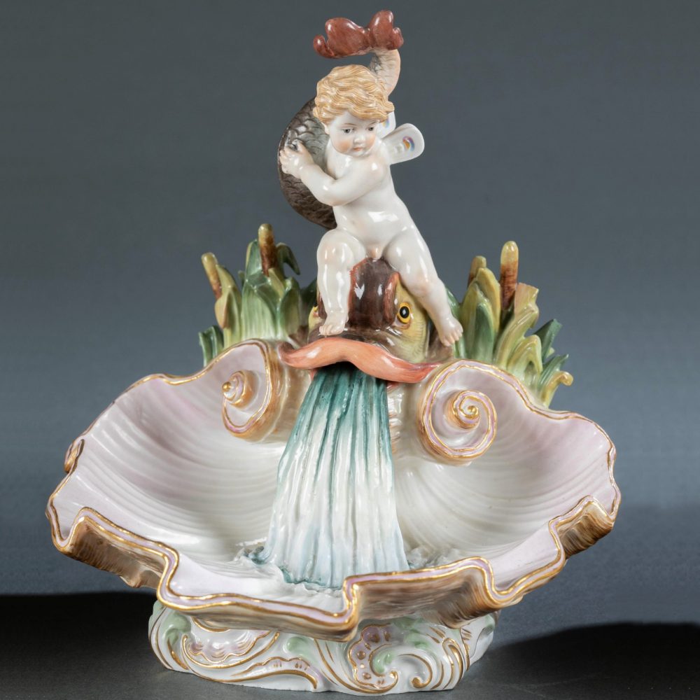 Meissen cupid on the shell holding a dolphin