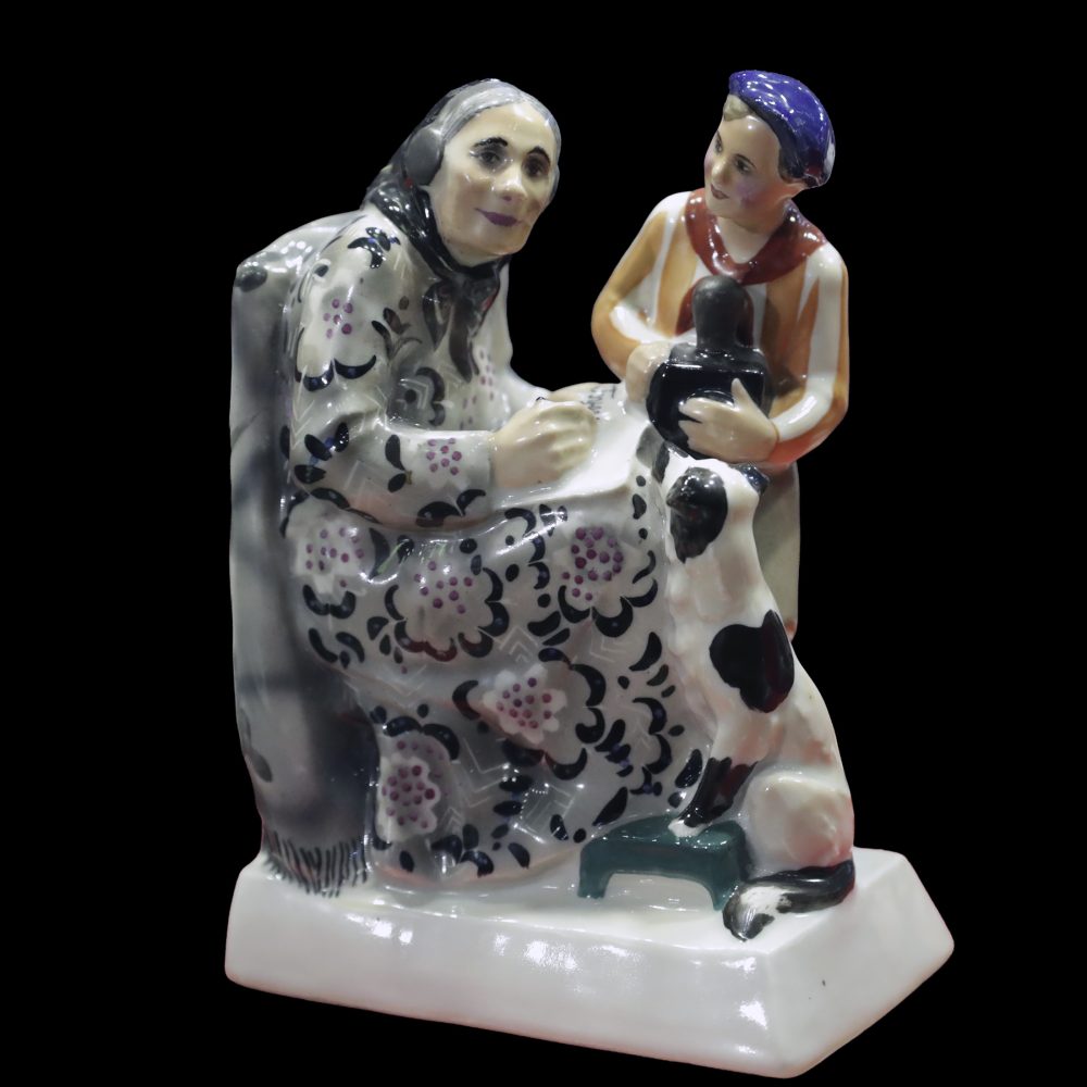 Soviet porcelain figural group depicting an old lady and young pioneer with the radio modeled by Natalya Danko